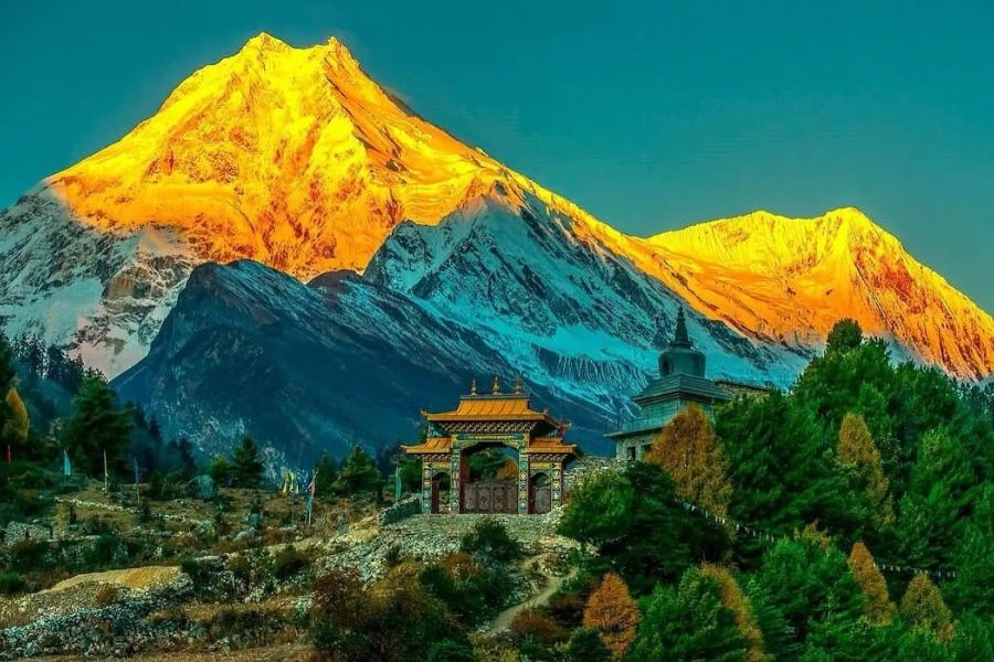 Manaslu peaks at sunrise with Buddhist monastery